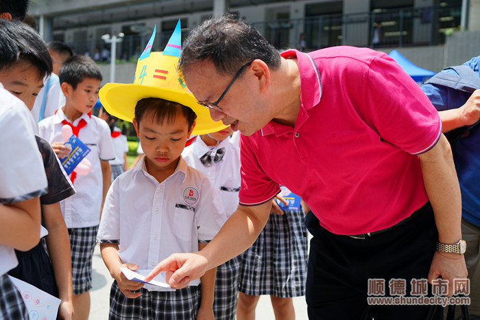 华南师范大学数学科学学科何小亚教授与孩子们一起参与数学游园活动。.jpg